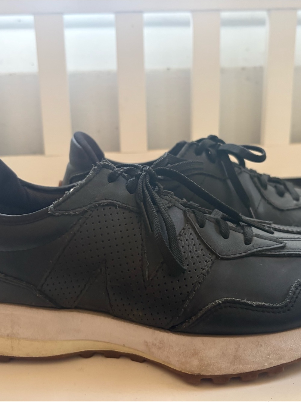 New Balance womenβs size 9.5 Black Perforated Leather Sneakers